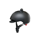 Matte black helmet with a small brim, black chin straps, a top mount, and a red rear light.