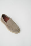 Taupe suede slip-on loafer with moccasin stitching, a vamp strap with three cutouts, and a light beige sole.