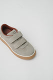 Taupe suede low-top sneaker with two velcro straps, 'CP' logo on tongue, brown leather lining, and a brown sole with a white