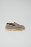 Taupe suede loafer with moccasin stitching, three brown-toned side eyelets, and a light beige sole.