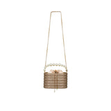 Front view of a David Charles crystal bucket bag featuring a large pearl handle, satin drawstring closure, and long gold chain strap
