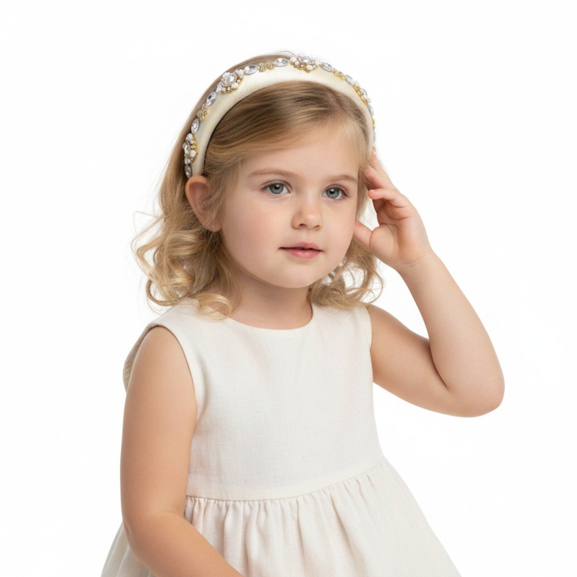 A young girl with dark curly hair looking back over her shoulder, wearing the colorful Dolce & Gabbana Carretto print top-knot headband.