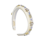 Side view of the David Charles girls' headband, highlighting the curve of the flexible band and the continuous multicolor print