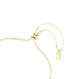 A macro close-up view of the Swarovski Imber bracelet's adjustable sliding bead fastener, showing the highly polished 18K gold finish and the dangling chain ends tipped with a branded octagonal swan tag.