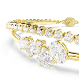 A detailed macro close-up shot set against a dark background, focusing on the Swarovski Mesmera bracelet's central cluster to emphasize the intricate prong settings and exceptional fire of the round, marquise, pear, and oval white crystals alongside the tennis chain.
