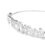 A detailed macro close-up shot focusing on the focal bar of the Swarovski Mesmera bracelet, emphasizing the crisp facet work, precise prongs, and multi-directional brilliance of the mixed marquise clear crystals.