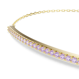 A detailed macro close-up shot focusing on the central curved bar of the Swarovski Only bracelet, emphasizing the flawless alignment of the prong-set, round-cut purple clear crystals.