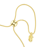 A macro close-up view of the Swarovski Mesmera bracelet's sliding bolo mechanism, displaying the highly polished gold-plated slider bead, parallel fluid chains, and the dangling octagonal tag engraved with the signature swan logo.