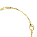 A macro close-up view of the Swarovski Mesmera bracelet's closure mechanism, highlighting the polished gold-finished lobster claw clasp, the sleek link chain, and the octagonal tag stamped with the signature swan emblem.