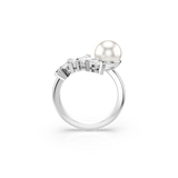 A direct side-profile view of the Swarovski Mesmera ring, illustrating the elevation of the round white crystal pearl and the layered, stair-stepped alignment of the brilliant marquise-cut white crystals over the finger contour.