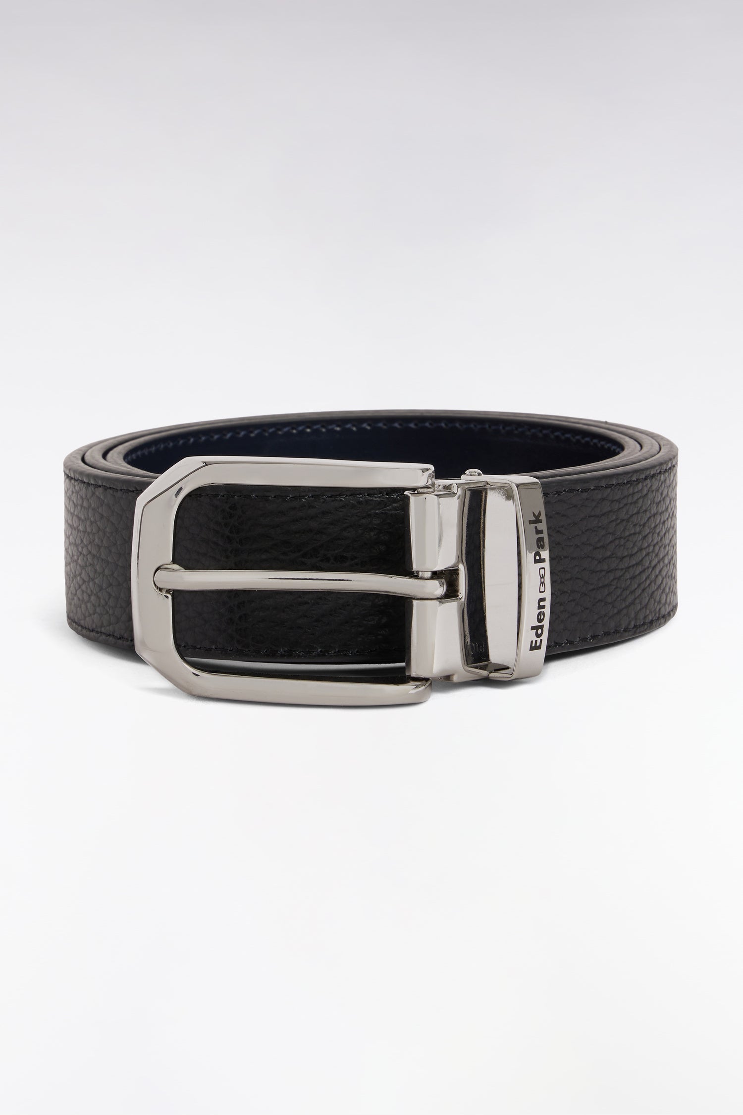 Reversible black pebbled leather belt with a dark blue interior and a silver-toned rotating buckle with 'Eden Park' engraved.