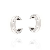 Pair of silver-toned metallic C-shaped ear cuffs with a polished finish and subtle raised ridge detail.