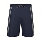 French blue swim shorts with elastic waist, white drawstring, and white double stripes on outer seams, with 'EMPORIO ARMANI'