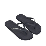 A pair of black rubber flip-flops. The left sole has 'EMPORIO ARMANI' in white, the right sole has 'EMPORIO' in white.