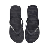 A pair of black flip-flops with subtle debossed lettering on the soles. White 'EMPORIO ARMANI' text is on the outer strap of