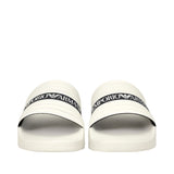 Pair of white slide sandals with ribbed straps, each featuring a black band with "EMPORIO ARMANI" and eagle logo.