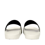 Smooth white slide slippers with wide black straps, viewed from the back.