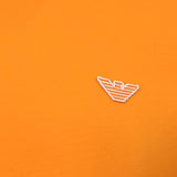 Bright orange fabric with a small embroidered logo featuring horizontal orange stripes outlined in white.