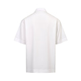 White short-sleeved collared shirt, back view. Lightweight fabric with folded cuffs and a straight hem.