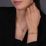 Gold-toned three-band ring with the top and bottom bands encrusted with clear stones, and a plain middle band.