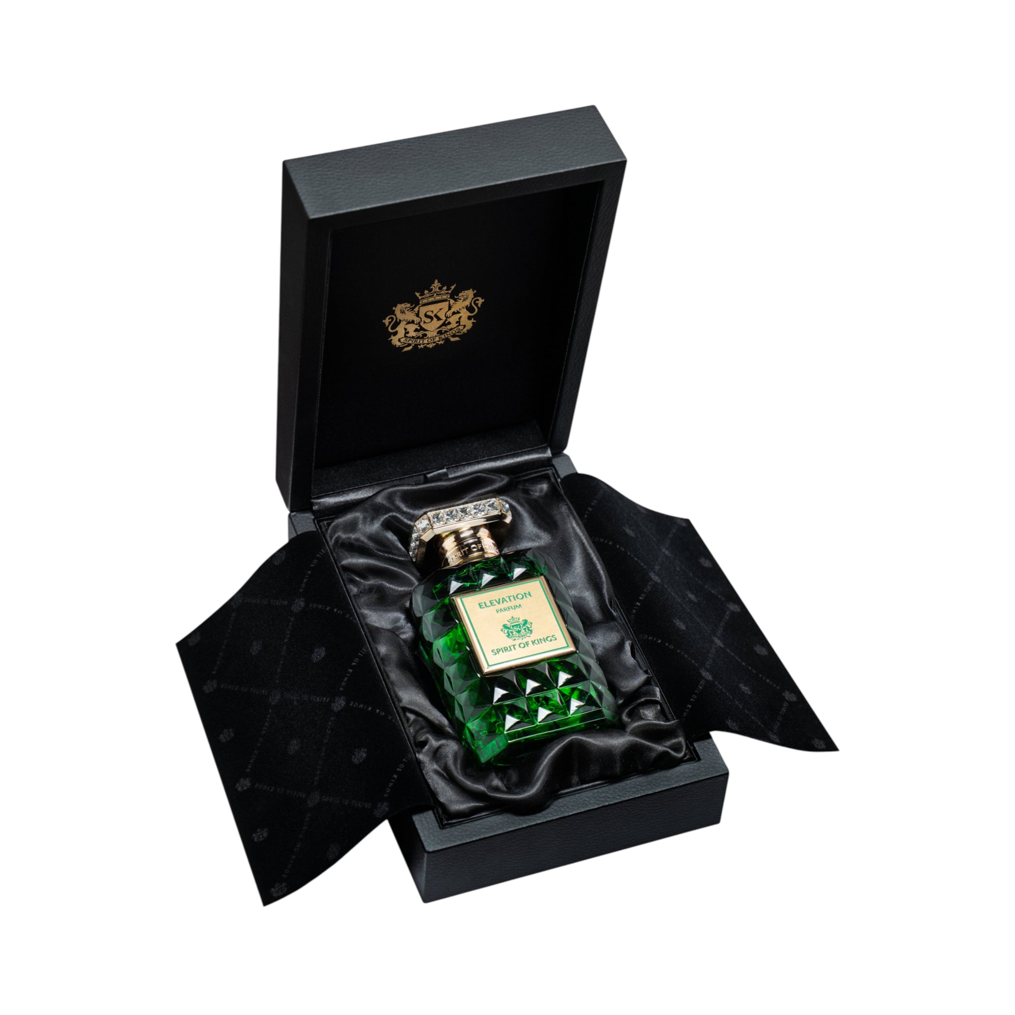 Dark green faceted perfume bottle with a gold-toned ornate cap and label, nestled in black satin inside an open black box wit