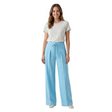A smiling model wearing the sky blue wide-leg drawstring pants from BLUE SALON shop paired with a simple grey t-shirt.