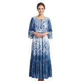Woman wearing a blue floral dress on a white background.