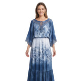 Woman wearing a blue and white floral dress on a white background.