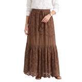 Full-length studio shot of a model wearing the brown ERMANNO FIRENZE embroidered eyelet maxi skirt, paired casually with a crisp white button-down shirt.