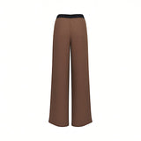 Back studio shot of the brown ERMANNO FIRENZE trousers, highlighting the clean fluid drape of the wide-leg silhouette and the continuous black waistband.