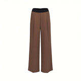Front studio shot of brown ERMANNO FIRENZE wide-leg trousers featuring a black elasticated logo waistband and tailored front pleats.