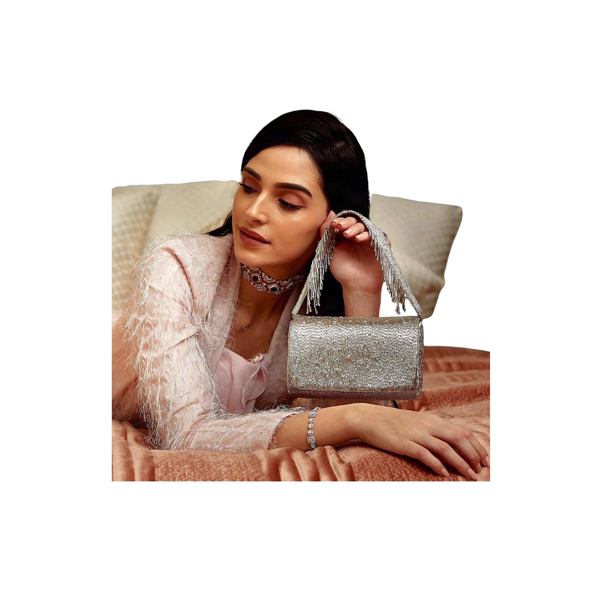 Lustrous silver flapover clutch bag covered in shimmering beads, with a short handle made of silver-toned beaded fringe.