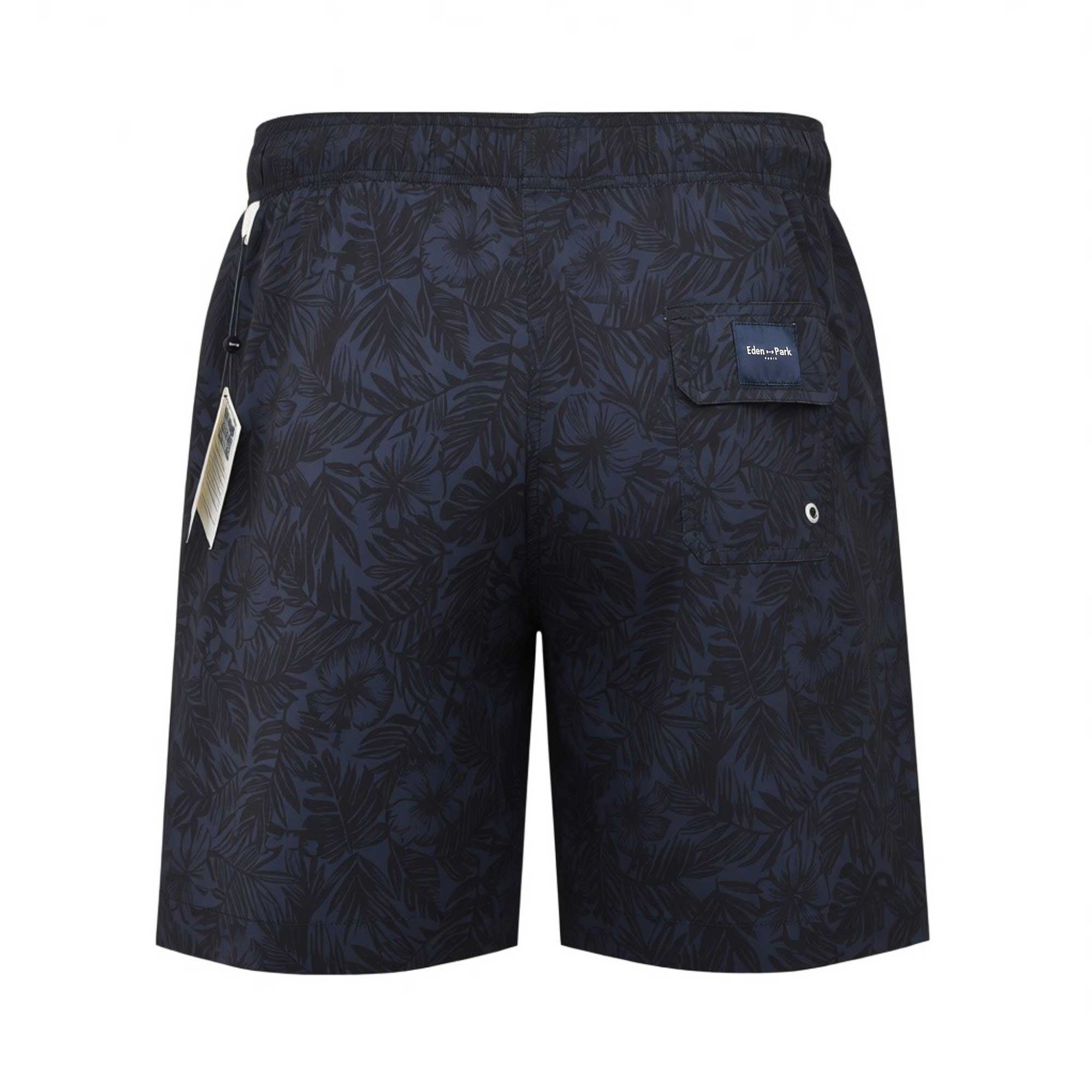 Back studio shot of the men's Eden Park tropical print swim shorts, showcasing the rear flap pocket with an embroidered logo patch and metal eyelet.