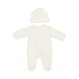 Full back view of an off-white baby romper and beanie set showing snap-button closures along the center back spine and a clean, seamless finish.
