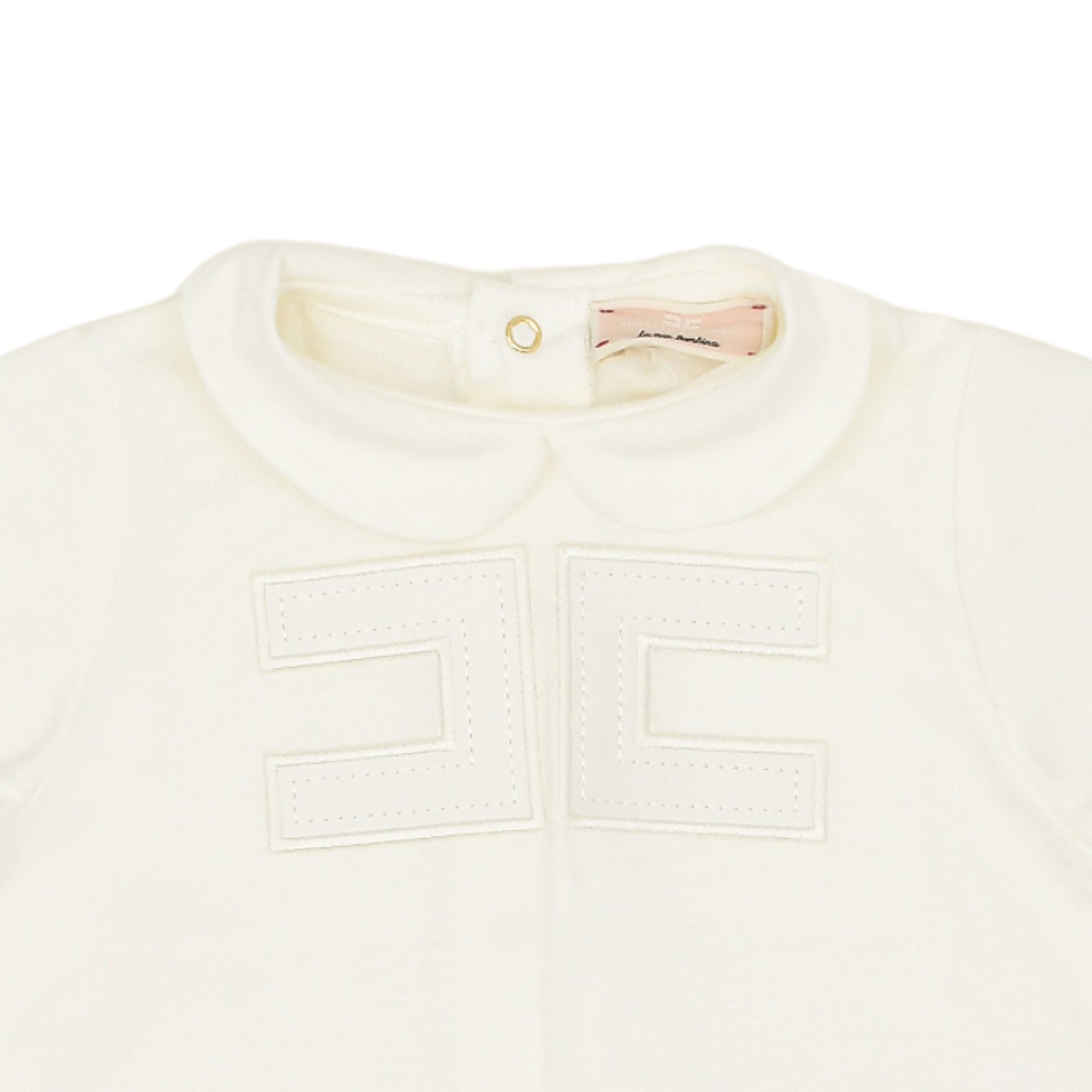 Close-up view of the upper bodice of an Elisabetta Franchi romper highlighting the round Peter Pan collar, inner brand tag, and stitched interlocking logo pattern.