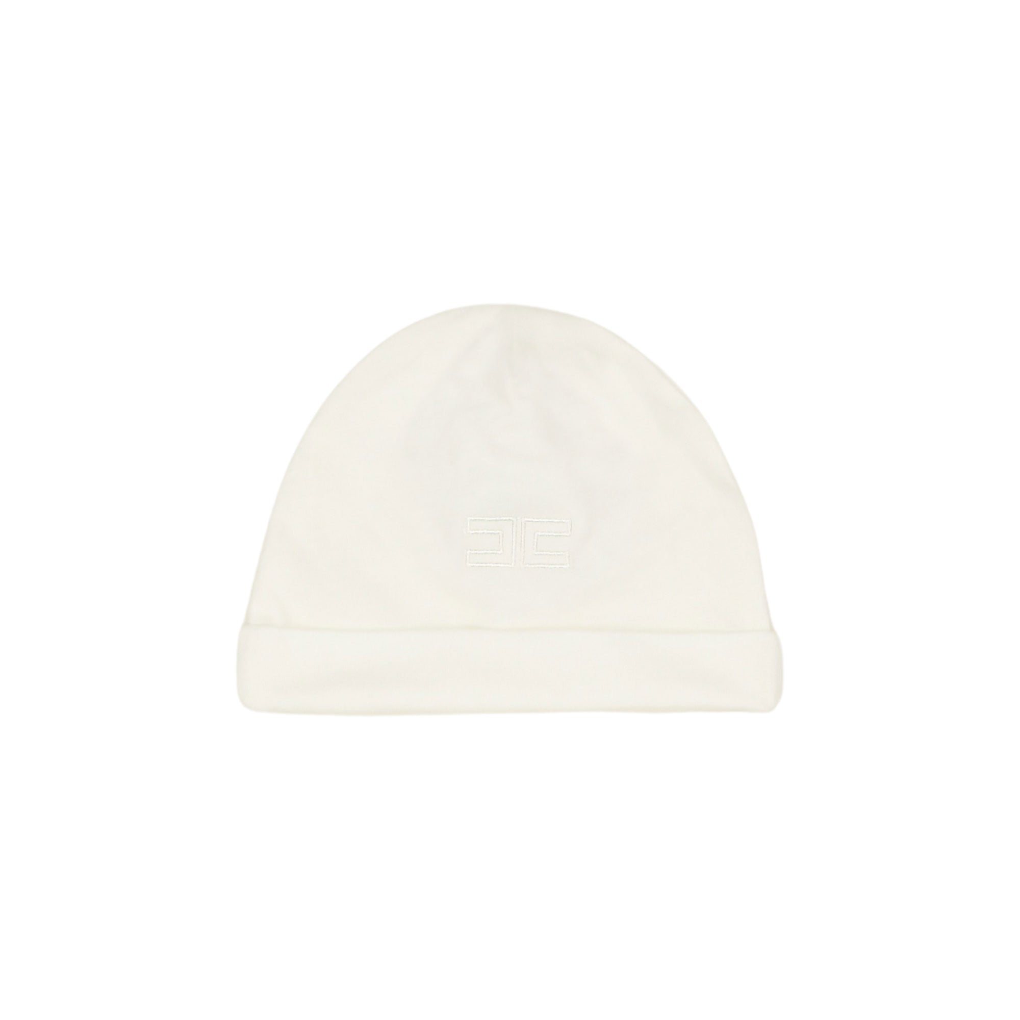 Front view of a soft off-white cotton jersey baby beanie hat featuring a turned-up brim and a small embroidered interlocking logo in the center.