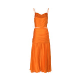 Rear view of the ELSAVA orange two-piece set highlighting the back zipper closure on the crop top and the seamless horizontal ruching across the hips of the midi skirt against a white background.