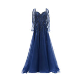 Front view of a navy Andrea & Leo Couture A-line gown with long embellished sleeves and a flowing tulle skirt.