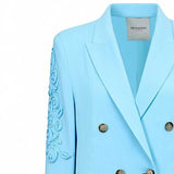 Light blue blazer with floral embroidery on sleeves and 'Ermanno' label.