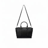 Full front view of the Ermanno Firenze black tote bag from BLUE SALON hanging from its long, adjustable crossbody strap against a clean white backdrop.
