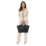 Woman holding a black handbag with a visible brand logo on a white background.