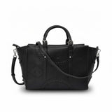Black handbag with detailed cut-out design on a white background.