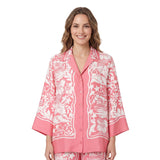 Front studio view of a smiling model wearing the Ermanno Firenze rose pink and cream tropical print pajama-style shirt from BLUE SALON shop.