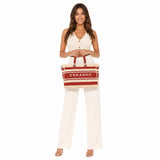 Woman holding a red and beige bag with 'Ermanno' branding on a white background.