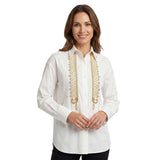 Woman wearing a white blouse with gold embroidery on a white background.