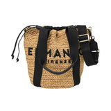 Close-up view of the Ermanno Firenze raffia bag from BLUE SALON with handles lowered, emphasizing the black fabric interior lining and adjustable drawstring cords.