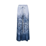 Front view of Ermanno women's wide-leg trousers featuring a blue ombré floral print and elasticated drawstring waistband from BLUE SALON shop.