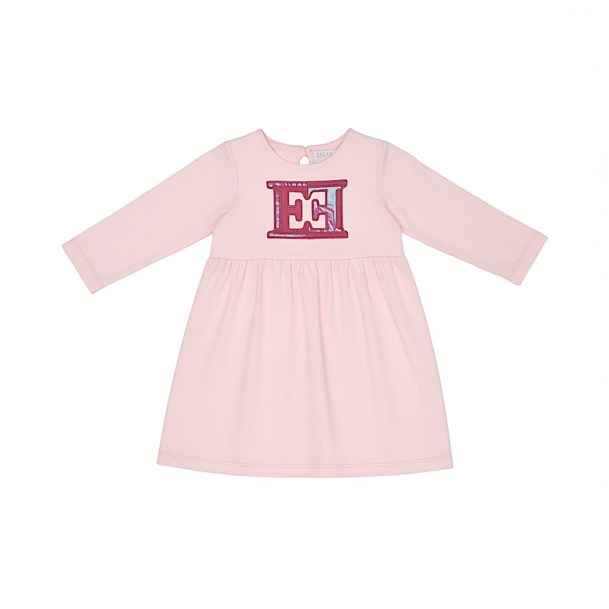 Front view layout of an Escada Kids girls long-sleeve dress in light pink, featuring a flared skirt and a prominent fuchsia and blue patterned chest logo applique.