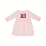 Front view layout of an Escada Kids girls long-sleeve dress in light pink, featuring a flared skirt and a prominent fuchsia and blue patterned chest logo applique.