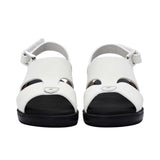 Pair of FARES brand white leather sandals with black soles and adjustable heel straps, featuring a modern geometric cutout design on a white background.